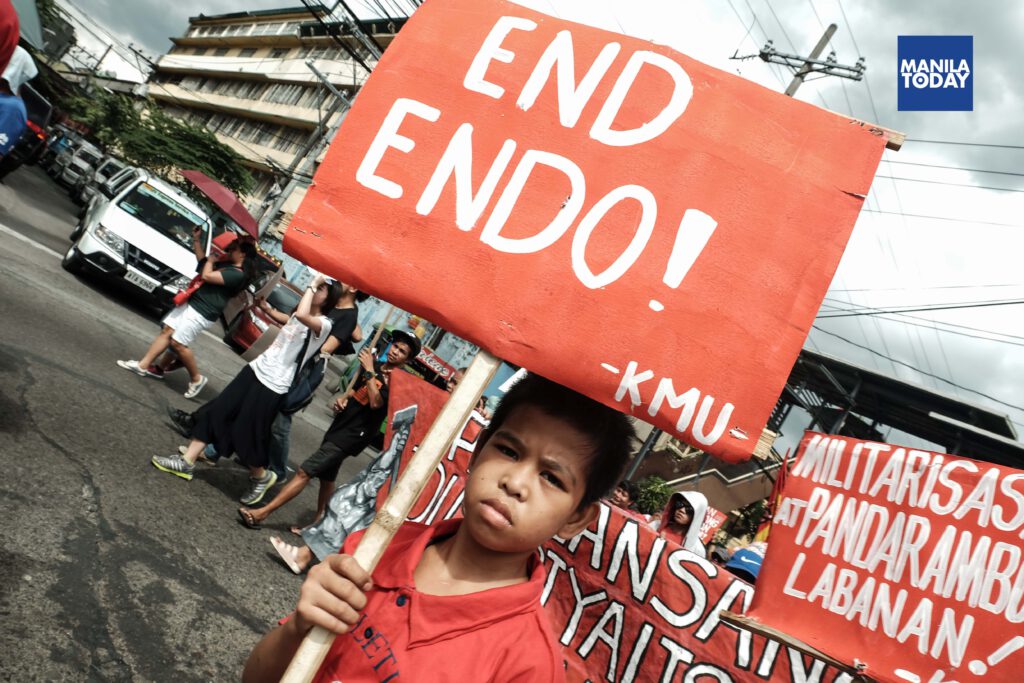 A worker's son join the march with a call to end 'endo'. (Manila Today/Joolia Demigillo)