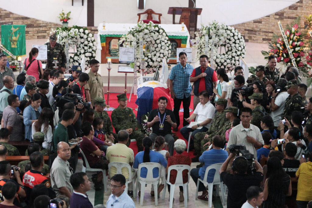President Rodrigo Roa Duterte speaks with Army officers and bereaved families of the three slain soldiers during his visit to the wake at St. Ignatius de Loyola Parish in Cagayan de Oro City on February 5, 2017. The government troopers were killed in an encounter with the NPA at Malaybalay, Bukidnon on February 1, 2017. ALBERT ALCAIN/Presidential Photo