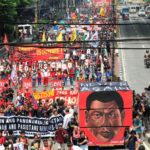 A cube effigy with a face of President Rodrigo Duterte is seen while protesters march toward the Malacanang presidential palace during a National Day of Protest in metro Manila